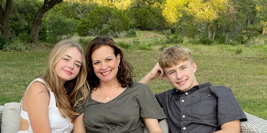 Robyn Smith with her two grown children, smiling together outdoors in Magnolia–Conroe, Texas.