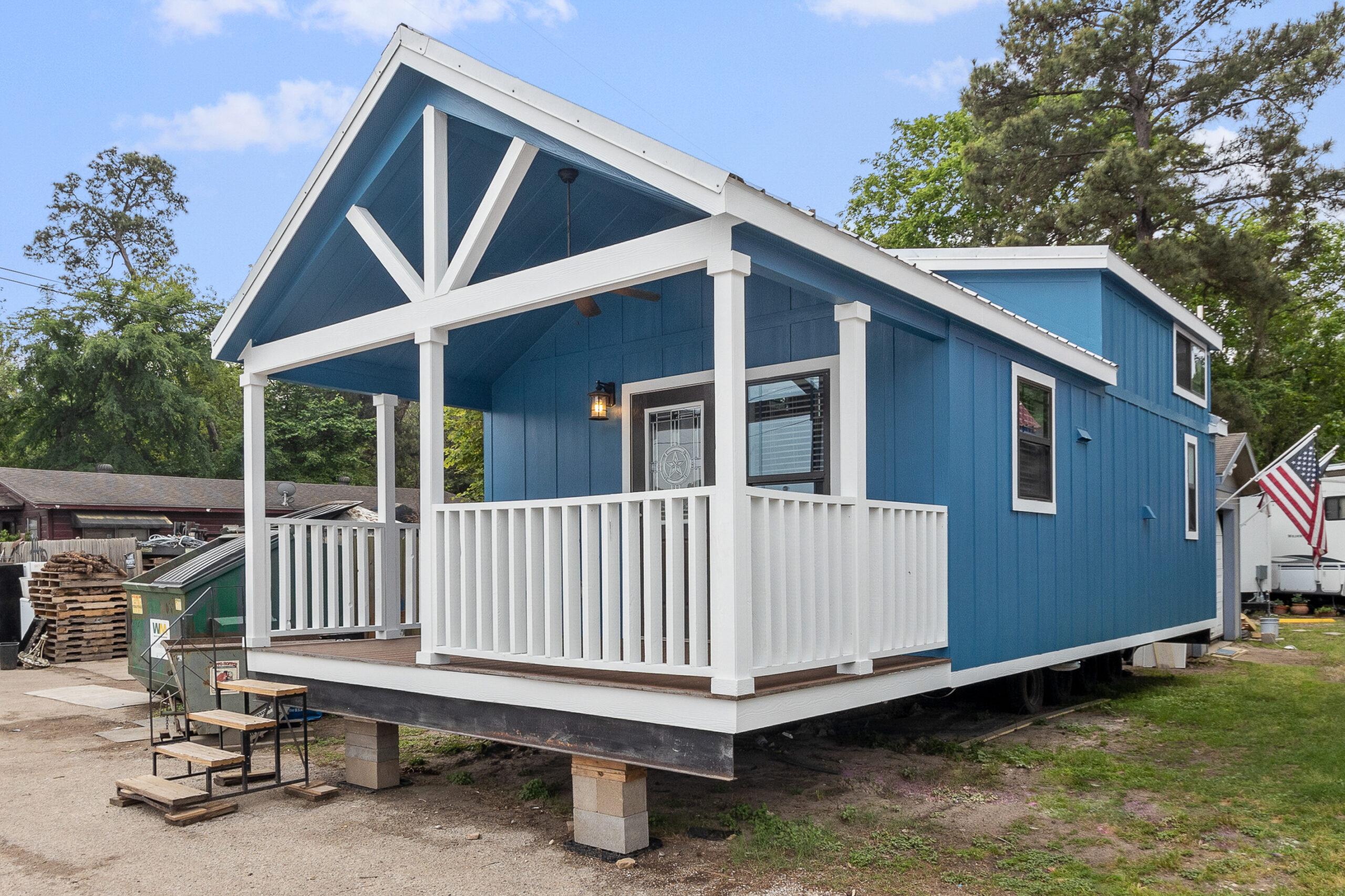 Exterior of the Big Blue tiny home with modern design and blue siding