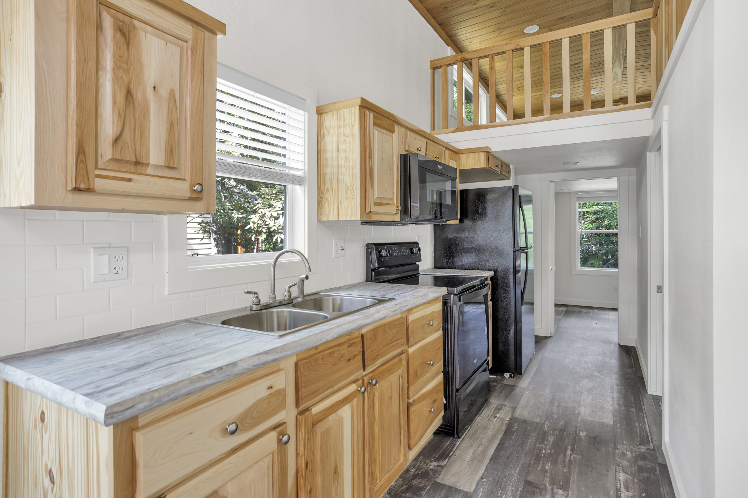 Kitchen interior of the Lark tiny home featuring modern cabinetry and efficient layout